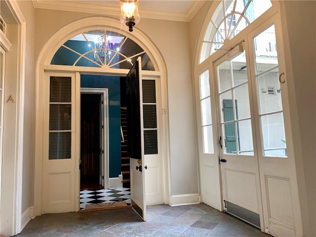 foyer featuring a notable chandelier and ornamental molding