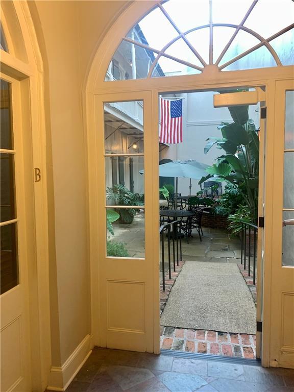 1225 Bourbon St Unit B, New Orleans, LA 70116 - entryway with stone finish floors and plenty of natural light