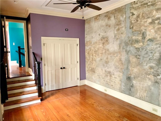 unfurnished room with ceiling fan, hardwood / wood-style floors, and crown molding