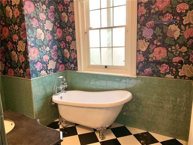 bathroom with tile walls and a tub