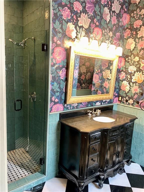 bathroom with vanity, tile walls, and walk in shower