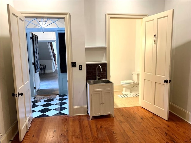 interior space featuring hardwood / wood-style floors, vanity, and toilet