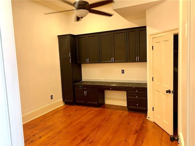 1225 Bourbon St Unit B, New Orleans, LA 70116 - unfurnished office featuring built in desk, ceiling fan, wood finished floors, and baseboards