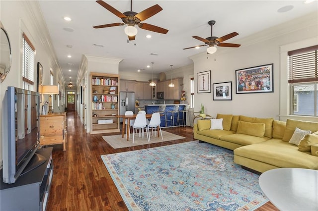 living room featuring dark hardwood / wood-style floors, ceiling fan, and ornamental molding