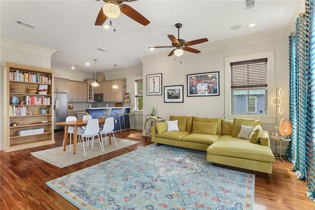 living room featuring crown molding, ceiling fan, and dark wood-type flooring