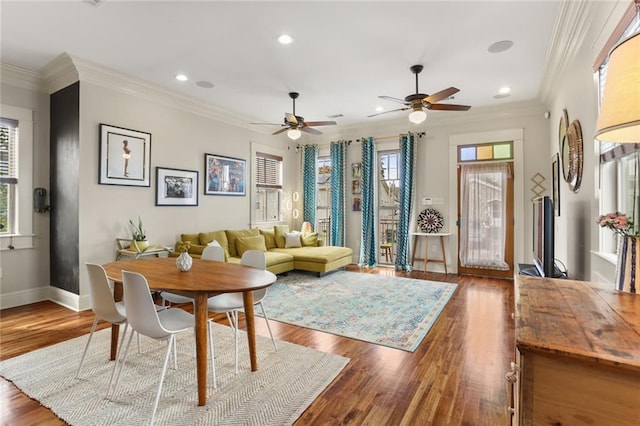 living room featuring a wealth of natural light, crown molding, and hardwood / wood-style flooring