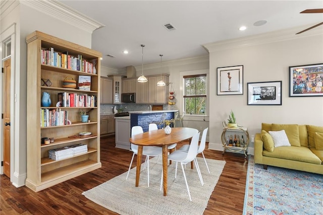 dining area with dark hardwood / wood-style flooring, ceiling fan, and ornamental molding