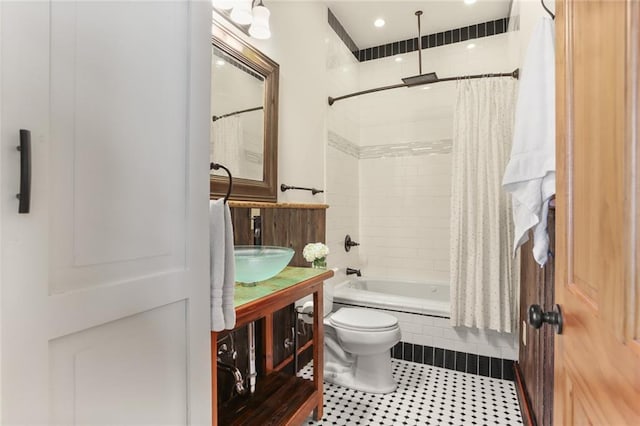 full bathroom featuring shower / bath combo, vanity, and toilet