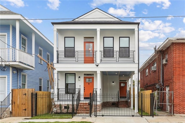 multi unit property featuring a balcony and covered porch