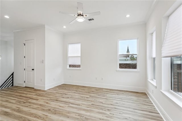 interior space with ornamental molding, light wood-type flooring, and ceiling fan