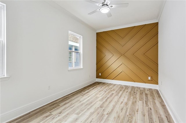 empty room featuring light hardwood / wood-style flooring, ceiling fan, and crown molding