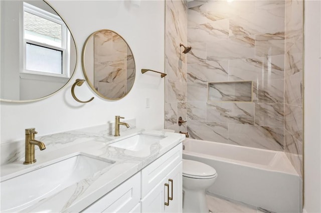 full bathroom featuring tiled shower / bath, toilet, and vanity