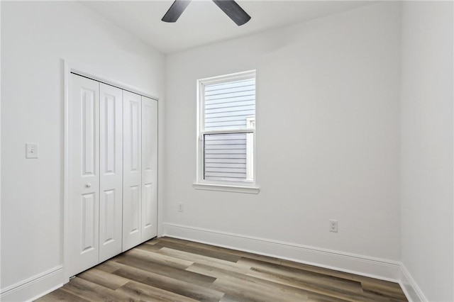 unfurnished bedroom with light hardwood / wood-style flooring, ceiling fan, and a closet