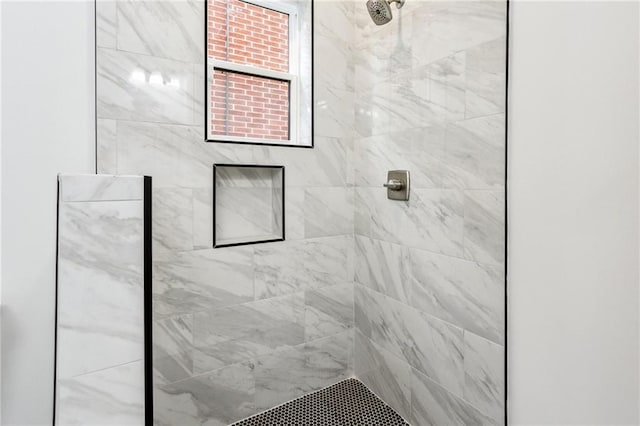 bathroom with a tile shower