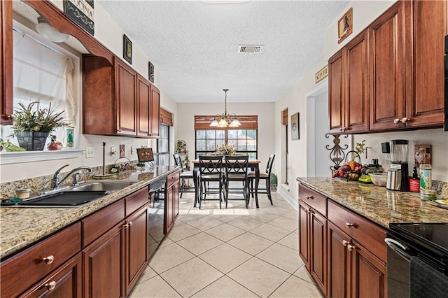 kitchen featuring dishwasher, a notable chandelier, a textured ceiling, sink, and decorative light fixtures