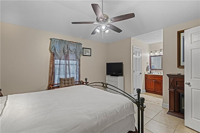 tiled bedroom featuring ceiling fan and connected bathroom