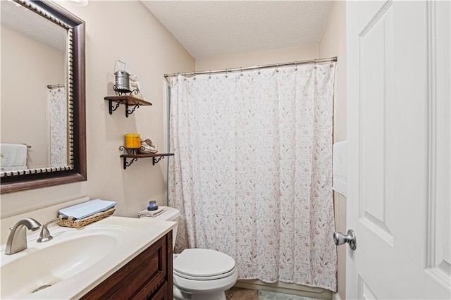 bathroom with vanity, a textured ceiling, and toilet