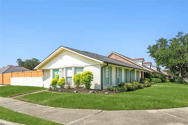 view of side of home featuring a yard