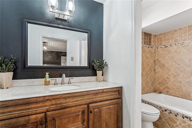 bathroom with a washtub, vanity, toilet, and tile patterned flooring