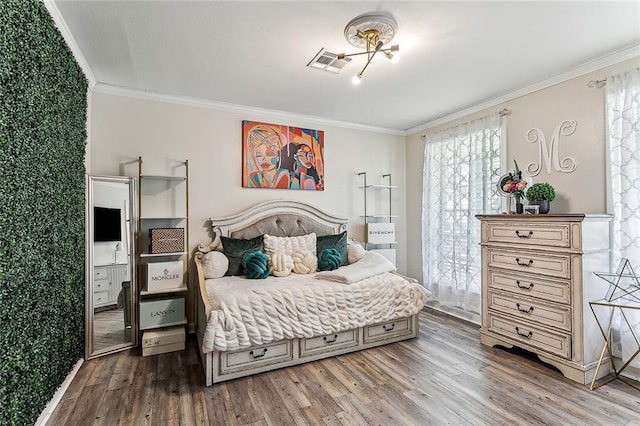 bedroom featuring wood-type flooring and ornamental molding