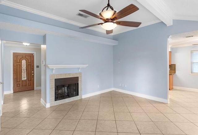 unfurnished living room featuring a tile fireplace, light tile patterned floors, lofted ceiling with beams, and ornamental molding