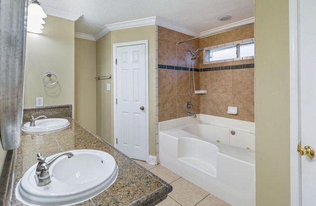 bathroom featuring tiled shower / bath combo, tile patterned flooring, vanity, and a textured ceiling