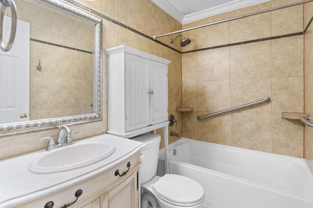 full bathroom featuring tiled shower / bath, a textured ceiling, vanity, crown molding, and toilet