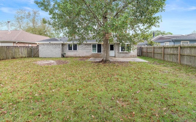 rear view of house featuring a patio and a lawn