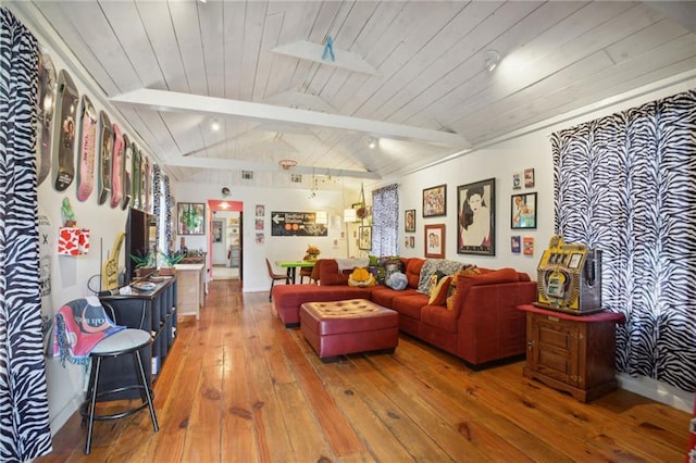 living room with hardwood / wood-style flooring, vaulted ceiling with skylight, and wooden ceiling