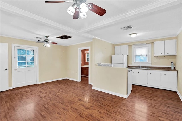 kitchen with dark hardwood / wood-style flooring, white refrigerator, and white cabinets