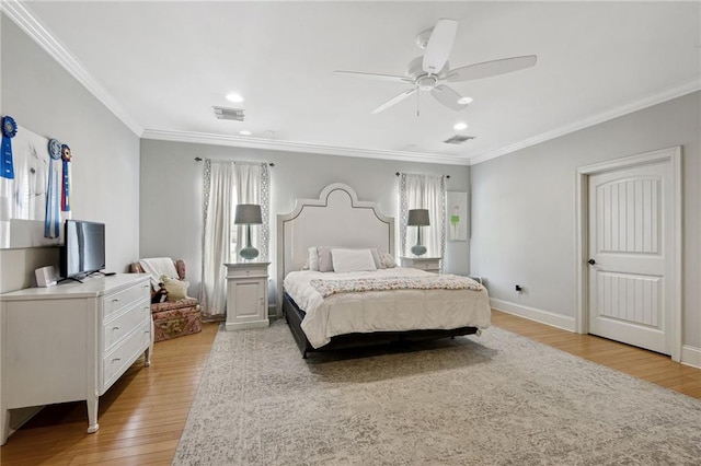 bedroom with light hardwood / wood-style floors, ceiling fan, multiple windows, and crown molding