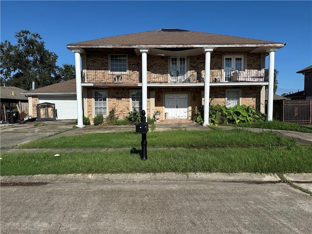 view of front of house featuring a balcony and a garage