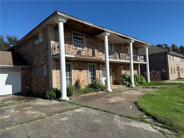 view of front of property with a balcony and a garage