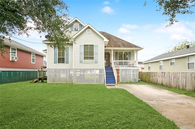 view of front facade featuring cooling unit, a front lawn, and covered porch