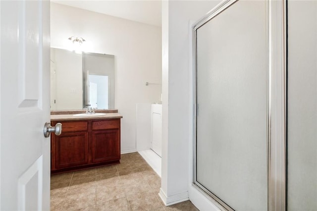 bathroom with vanity, a shower with door, and tile patterned floors