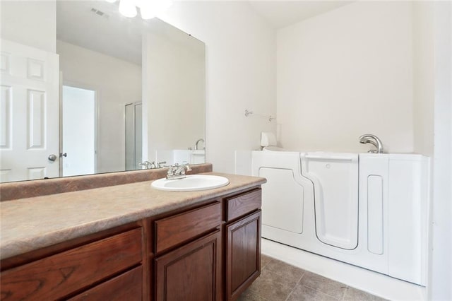 bathroom featuring tile patterned flooring and vanity