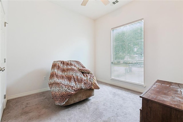 sitting room with light colored carpet and ceiling fan