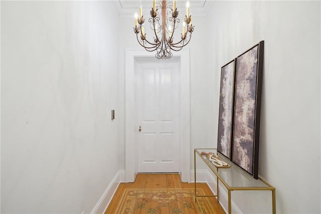 corridor with ornamental molding and hardwood / wood-style floors