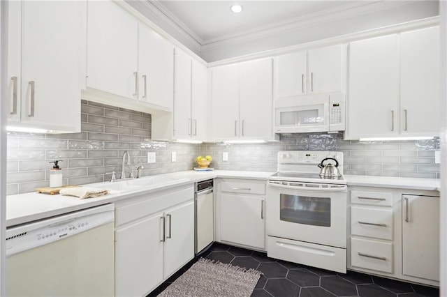 kitchen with white cabinets, white appliances, dark tile patterned flooring, and tasteful backsplash