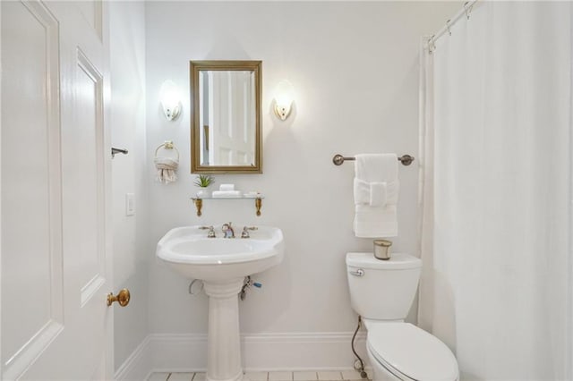 bathroom with tile patterned flooring and toilet