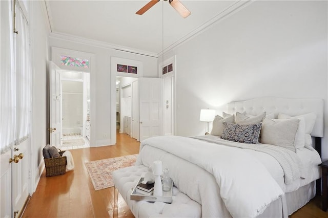 bedroom with hardwood / wood-style flooring, ceiling fan, crown molding, and ensuite bathroom