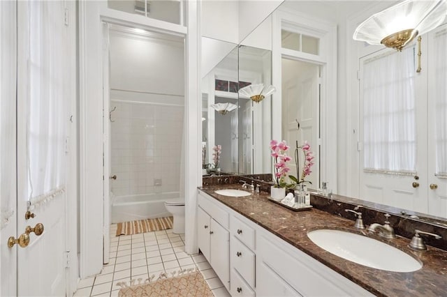 full bathroom featuring tiled shower / bath, vanity, toilet, and tile patterned floors