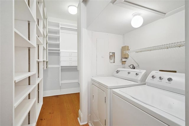 laundry area featuring hardwood / wood-style flooring and separate washer and dryer