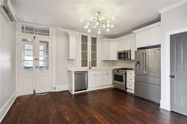 kitchen with dark hardwood / wood-style floors, a wall mounted AC, high quality appliances, and white cabinetry