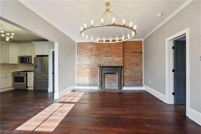 unfurnished living room with dark hardwood / wood-style flooring, brick wall, ornamental molding, and a brick fireplace