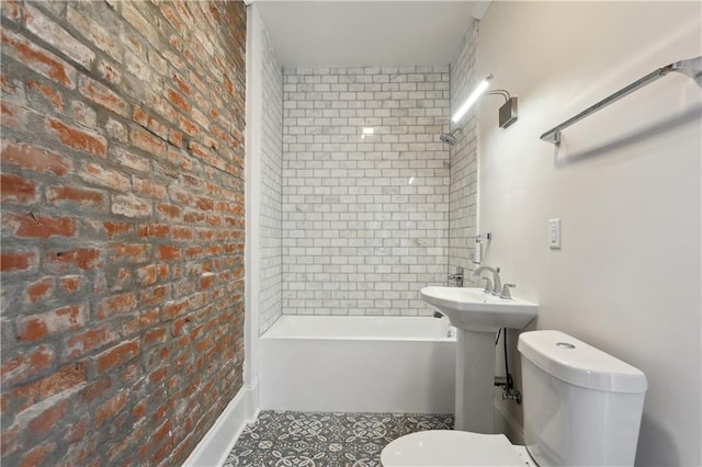 bathroom with brick wall and toilet