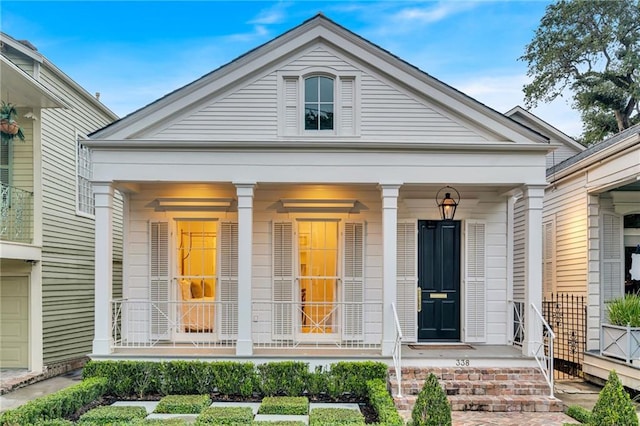 view of front facade with a garage and covered porch