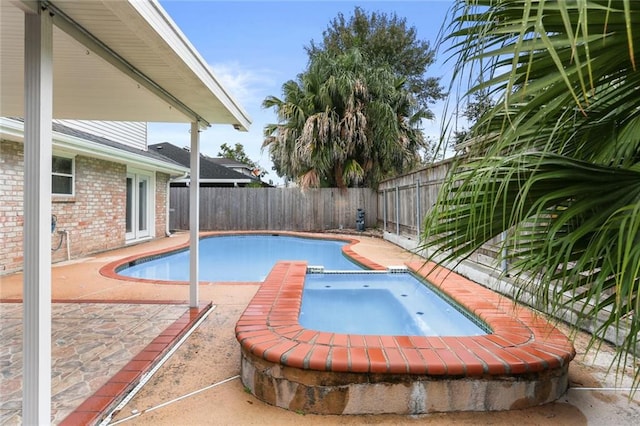 view of pool featuring a patio and an in ground hot tub