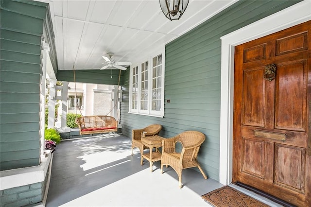 doorway to property with a porch and ceiling fan