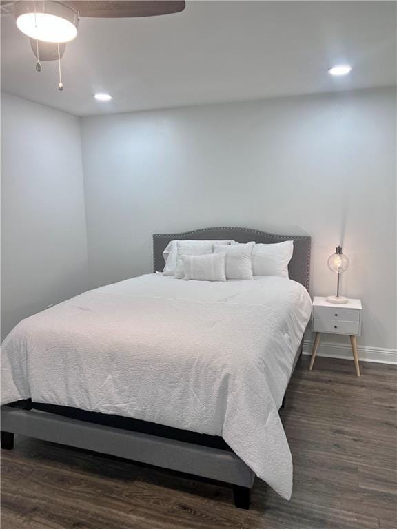 bedroom featuring ceiling fan and dark wood-type flooring